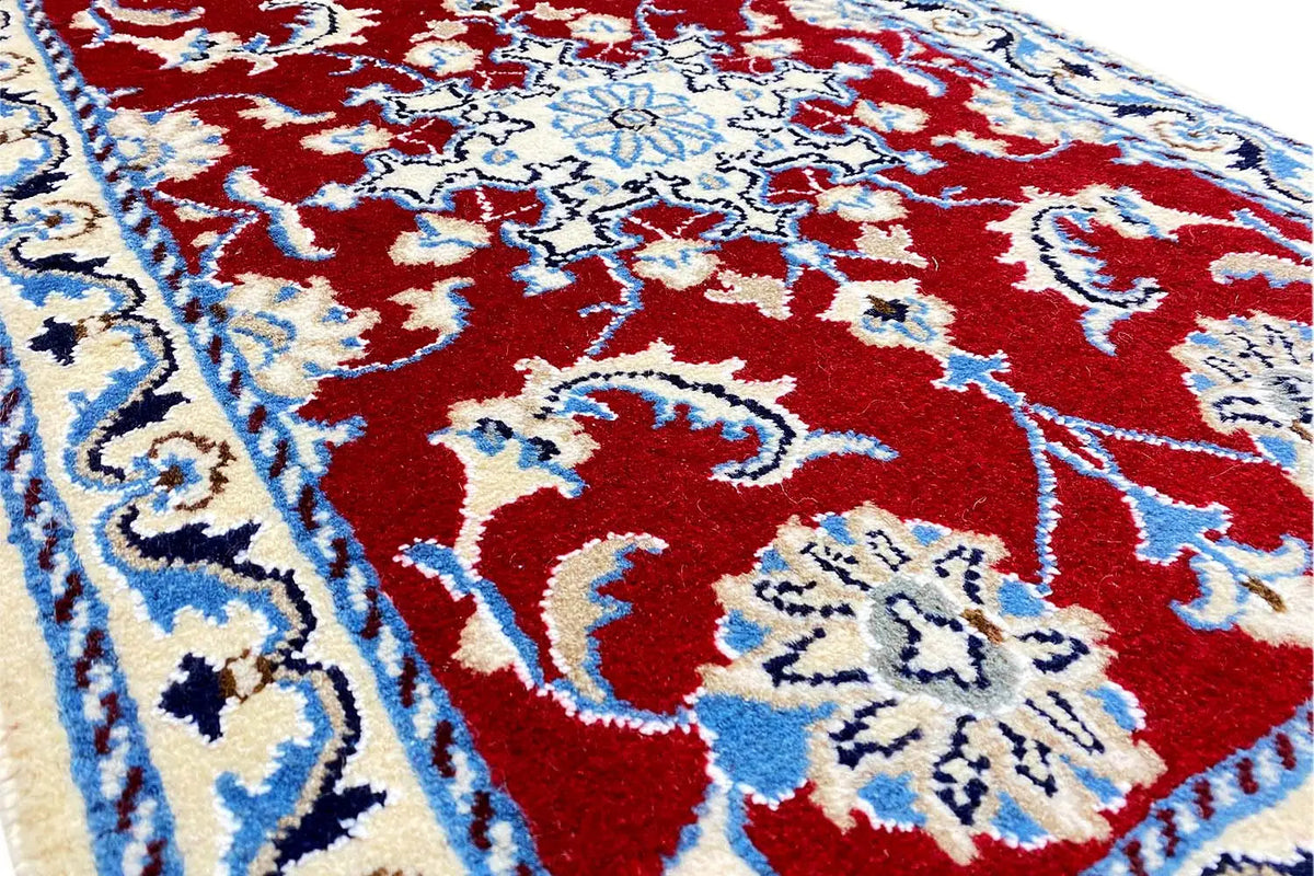 Nain rug 87x59 cm close-up: red ornamental motif in blue and white