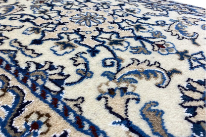 Nain rug with a dense pile, blue ornamental pattern on a light background