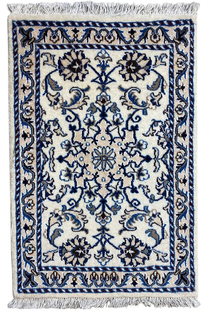 Wool rug 85x60 cm with blue ornamental design and fringes along the edge