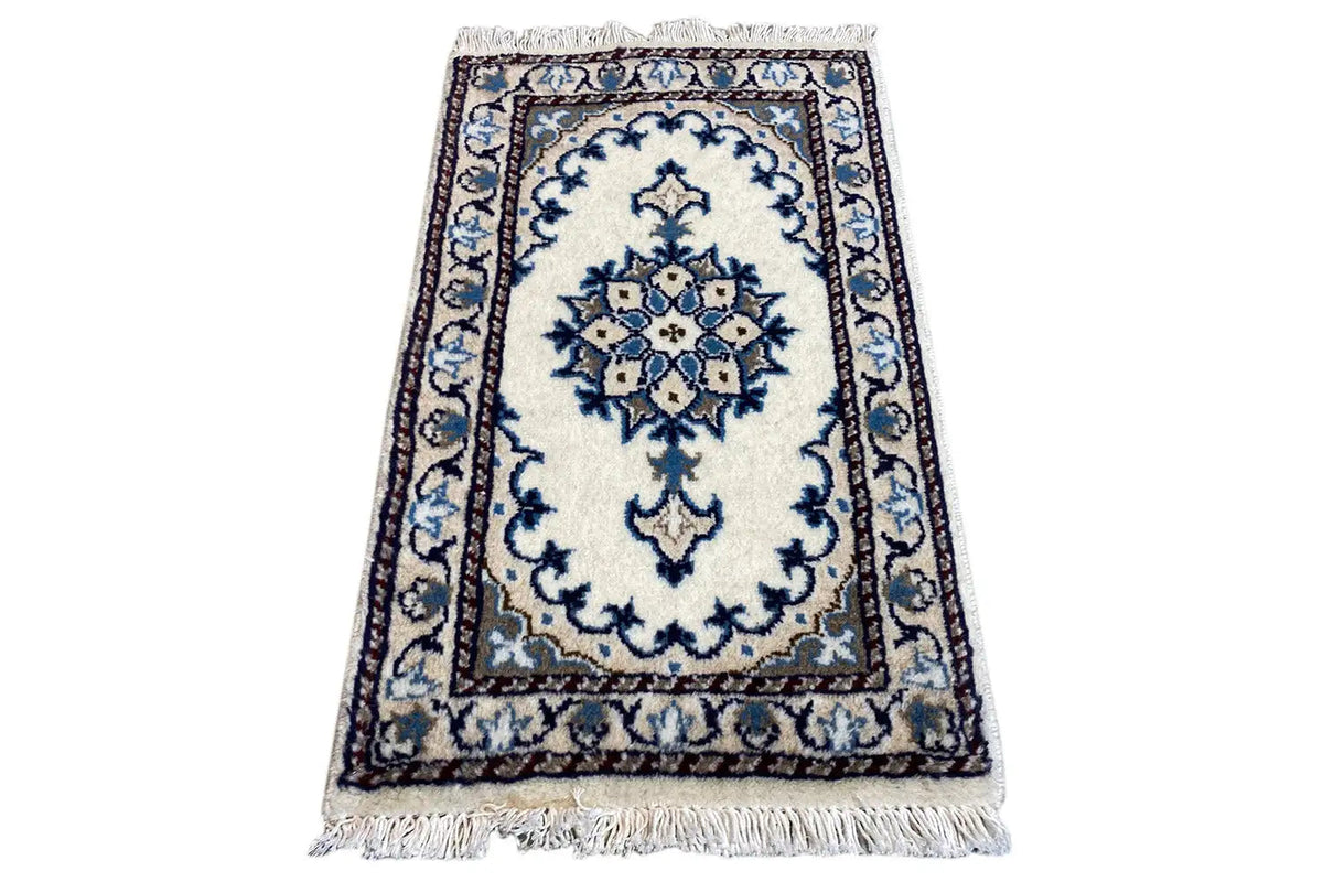 Oriental rug 65x38 cm, rectangular, light-colored with a blue decorative pattern and fringes along the edge