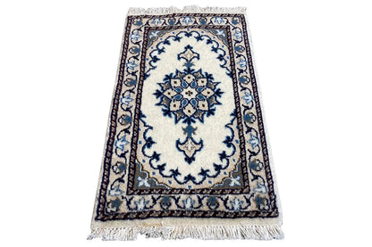 Oriental rug 65x38 cm, rectangular, light-colored with a blue decorative pattern and fringes along the edge