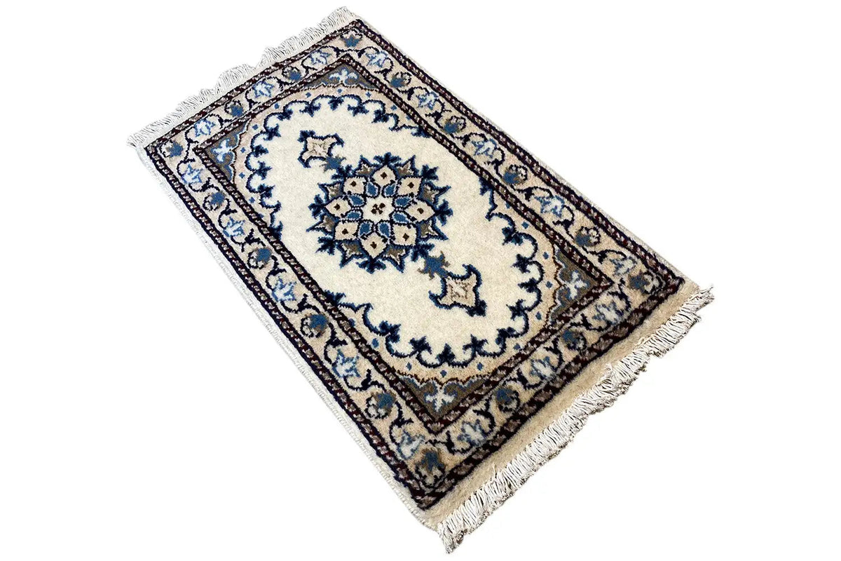 Oriental rug 65x38 cm, angled, with a blue border ornament and fringes at the corners