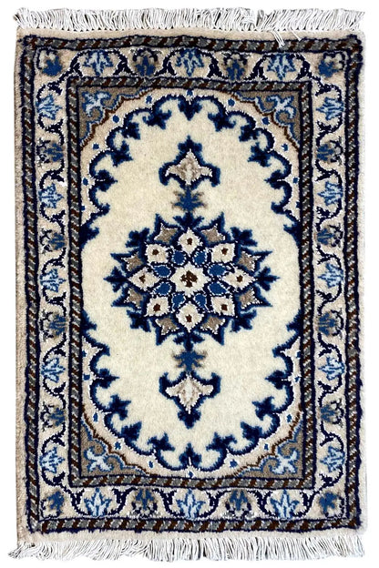 Oriental rug 65x38 cm with a blue ornamental pattern on a light background and fringes