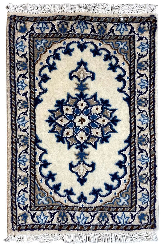 Oriental rug 65x38 cm with a blue ornamental pattern on a light background and fringes