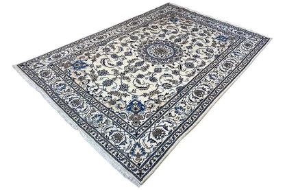 Nain-design rug, blue-and-white floral motifs, fringes along the edge
