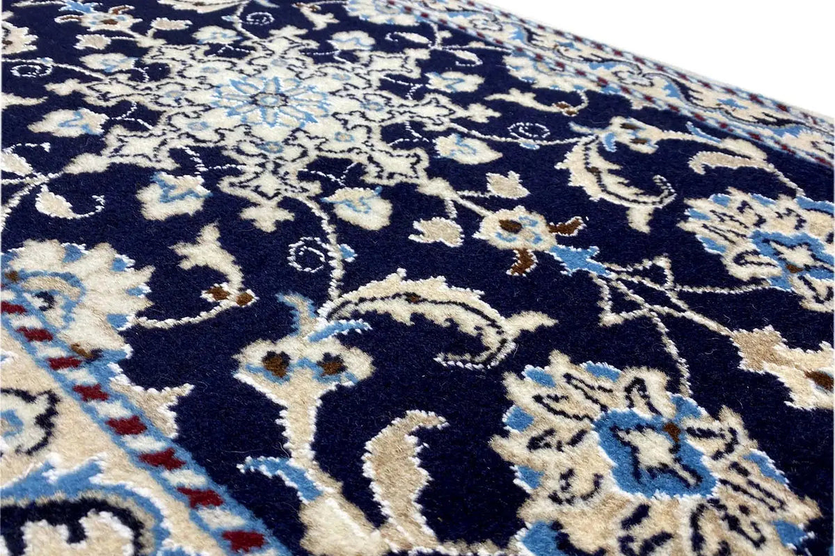 Nain rug 90x59 cm, detailed view with dark blue ornamental pattern and light accents