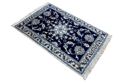 Rectangular rug, dark blue with floral ornaments in light blue and beige, with fringes