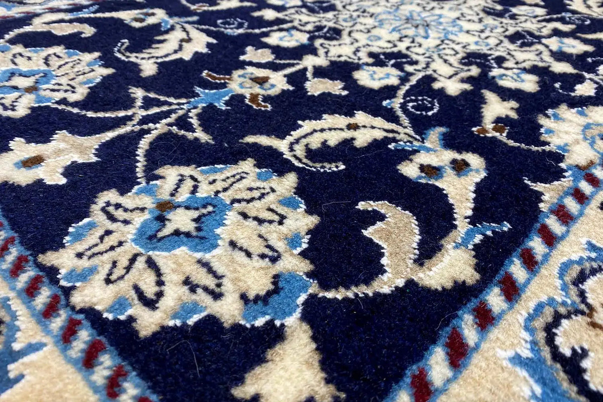 Nain rug 90x61 cm close-up: dark blue pattern with beige and light blue flowers