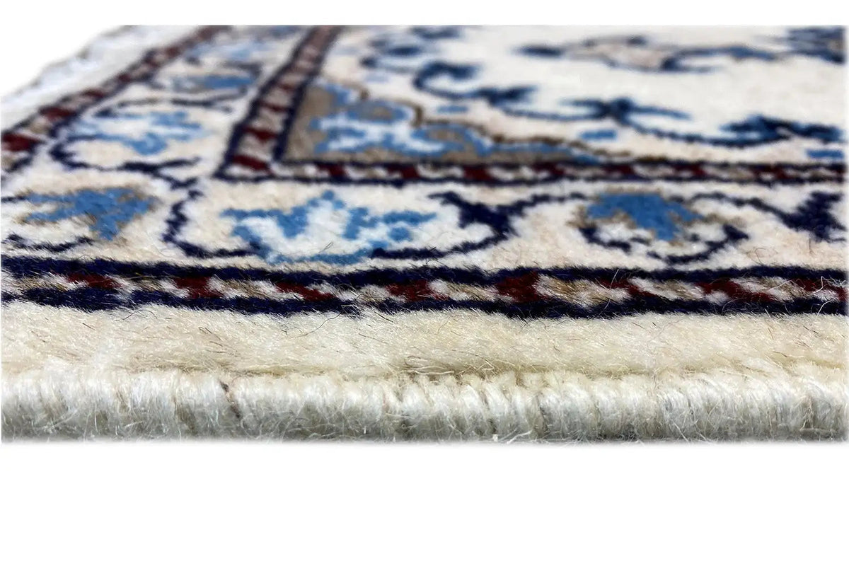 Carpet edge with fringes along the border, close-up of the white and blue pattern