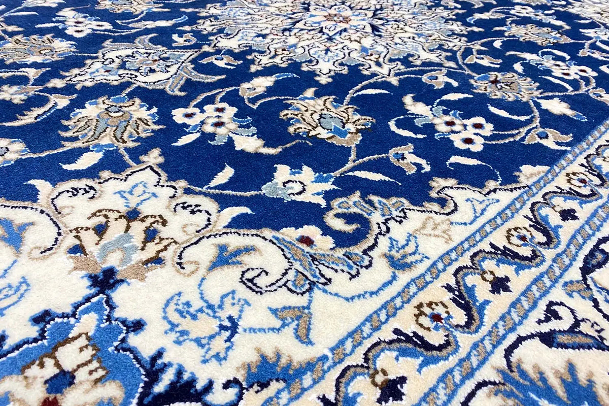 Close-up of the Nain carpet: blue ground fabric with white floral ornaments