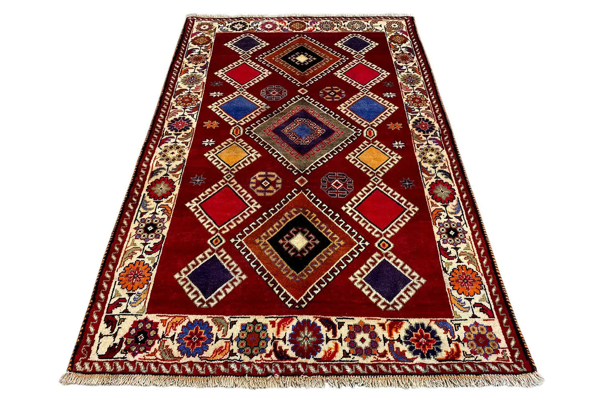 Oriental rug, rectangular, red base with geometric motifs and fringes