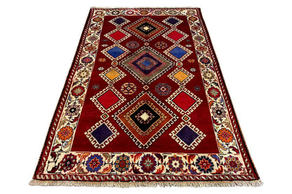 Oriental rug, rectangular, red base with geometric motifs and fringes
