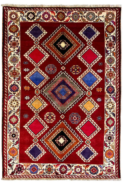 Oriental rug with a red background, geometric pattern in blue, beige, and black, border