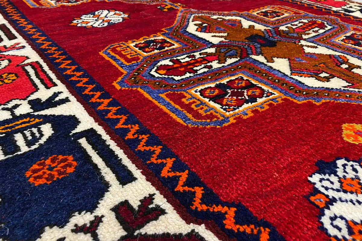 Close-up: red carpet pattern with geometric ornaments and a colorful border trim
