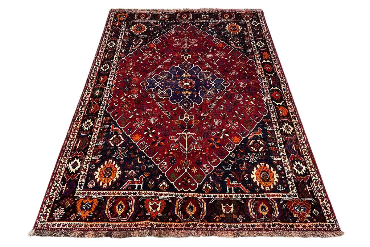 Oriental rug, red with blue medallion, border, and short fringe