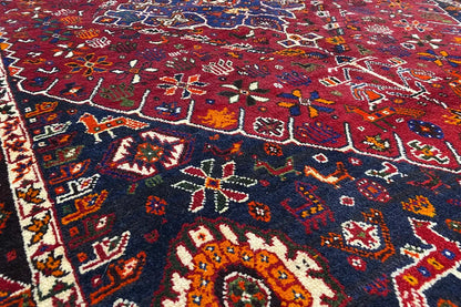 Close-up: red carpet with an intricate ornamental pattern in blue, yellow, and white