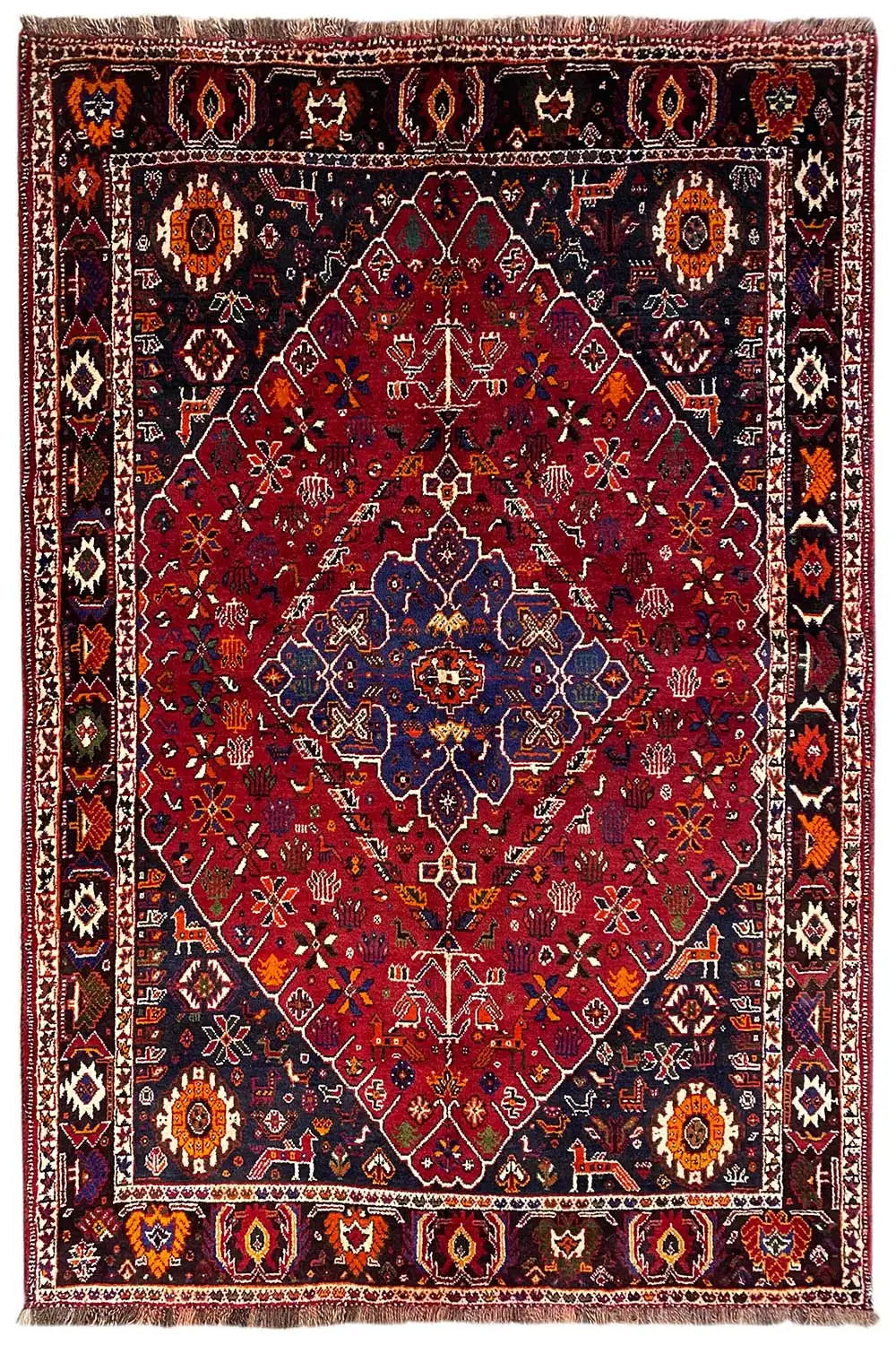 Oriental rug with a red pattern, blue medallion, and multicolored border