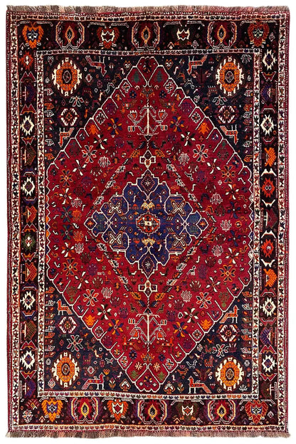 Oriental rug with a red pattern, blue medallion, and multicolored border