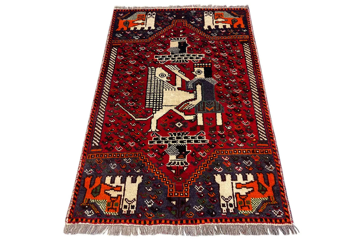 Carpet 131x88 cm with a red ground, medallion and animal motifs, fringes along the edge