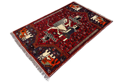 Rug 131x88 cm with a red pattern, geometric borders, and fringes at the corners