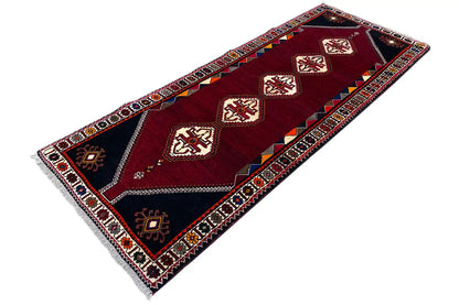 Burgundy runner rug with dark corner panels and white diamond details