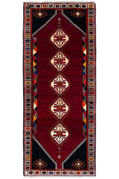 Burgundy runner rug with geometric diamonds and a decorative border