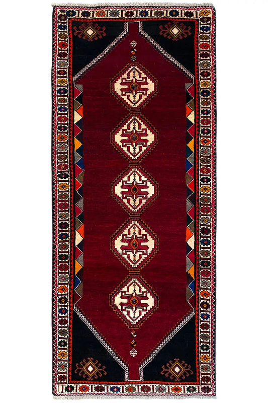 Burgundy runner rug with geometric diamonds and a decorative border