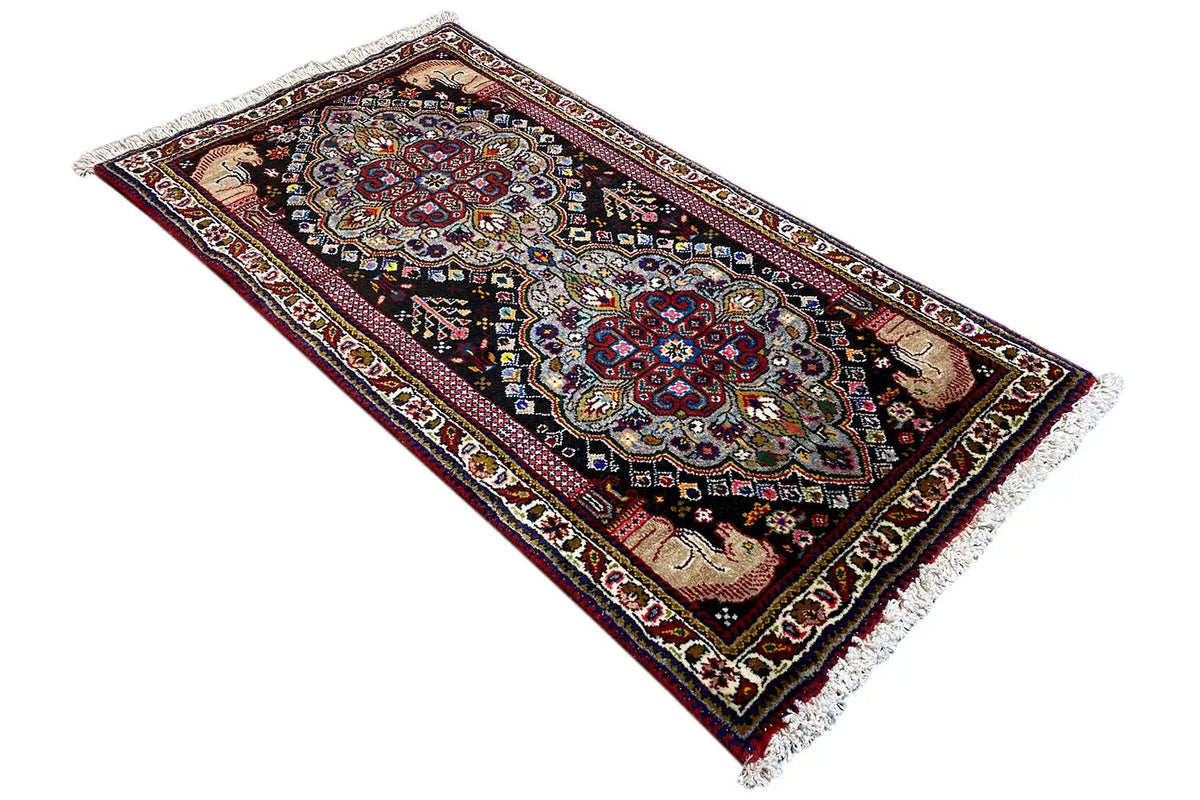 Oriental rug with two medallions, colorful border and fringes, 114x59 cm.