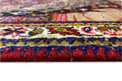 Carpet pile in detail with colorful ornaments and dense pile, red border.