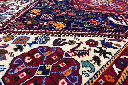 Detail of the carpet pattern with a blue background, colorful geometric motifs and ornaments