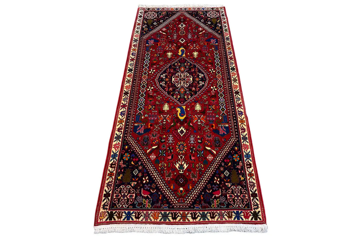Oriental rug with a red ground, central medallion, and dark border bands, 206x85 cm