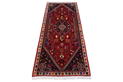 Oriental rug with a red ground, central medallion, and dark border bands, 206x85 cm