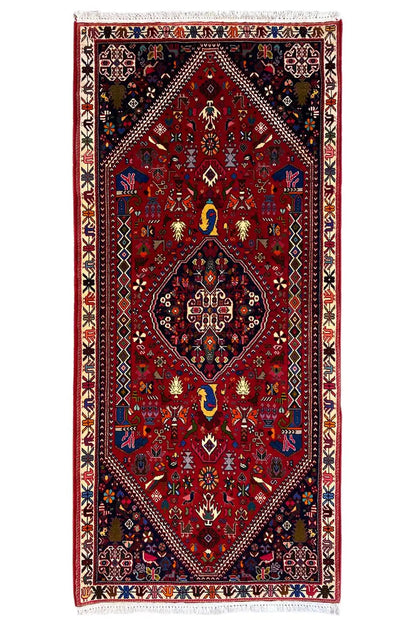 Oriental rug with a red ground and geometric medallion, blue and gold ornaments, 206x85 cm