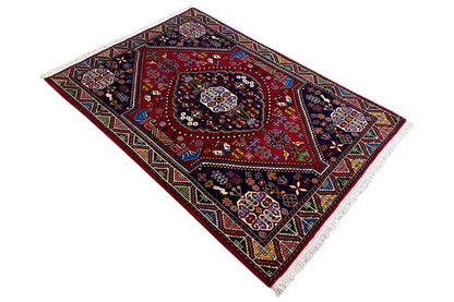 Oriental rug with a red central field and dark border, diagonal pattern with ornaments