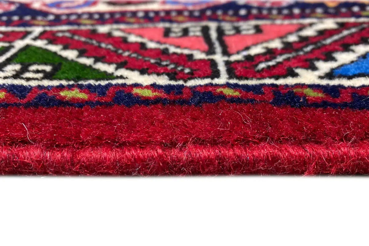 Carpet detail: red pile at the edge with white fringes