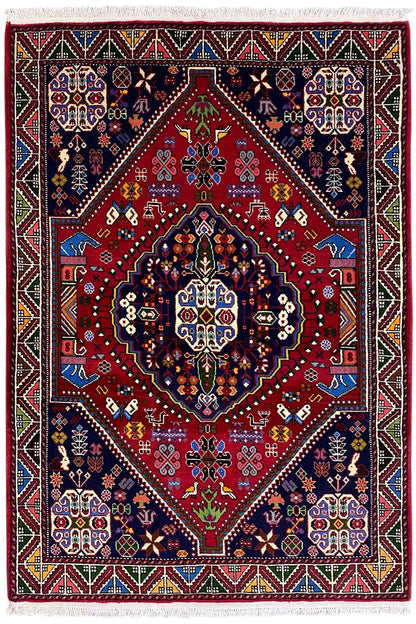 Oriental rug with a red field, dark blue medallions, and a multicolored decorative border