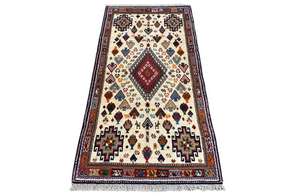 Oriental rug with geometric pattern in cream, blue, red, and yellow, 137x72 cm
