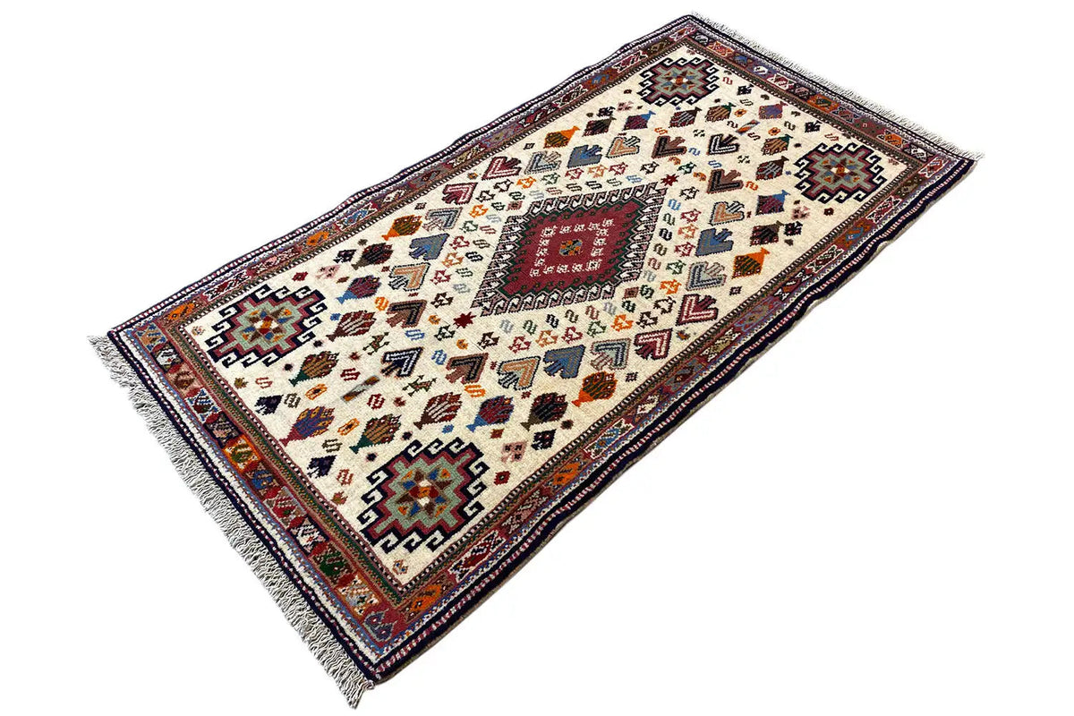 Oriental rug in landscape format with a geometric pattern, multicolored on cream, 137x72 cm