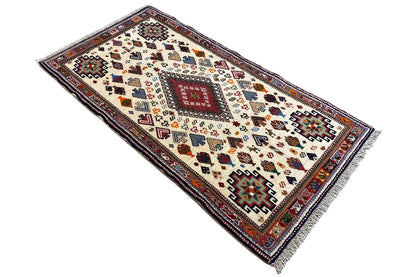 Landscape-format oriental rug with a geometric border, cream-colored, 137x72 cm