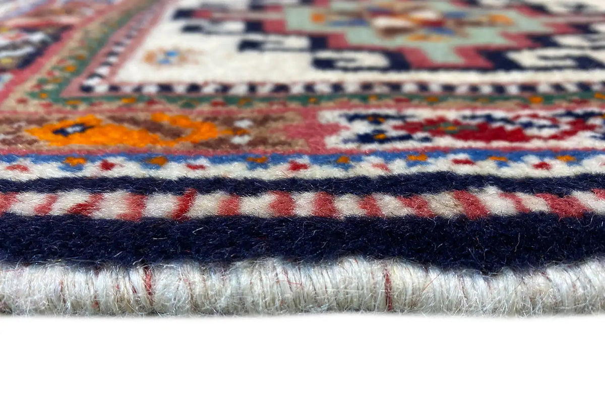 Oriental rug: close-up of fringes and edge border, multicolored on cream