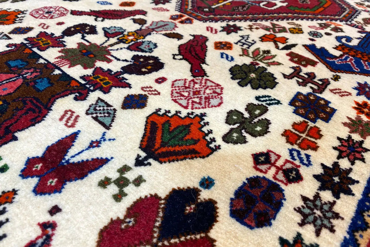 Close-up of carpet pile with colorful geometric patterns in red, blue, and green
