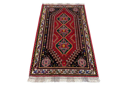 Rug with an oriental border pattern, red, dark blue and colorful accents, fringes