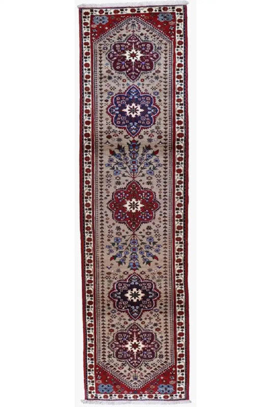 Rectangular runner with a centered medallion pattern in red, blue, and beige