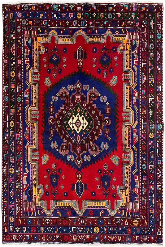 Sirjan rug (250×166 cm) in red, blue, and beige with a large central medallion