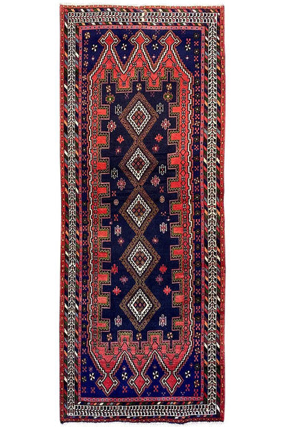 Sirjan runner, blue rug with a red and black ornamental pattern, rectangular.