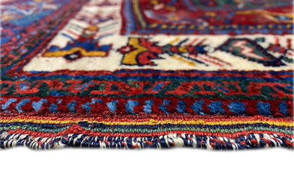 Carpet detail: colorful patterned border and white fringe along the edge