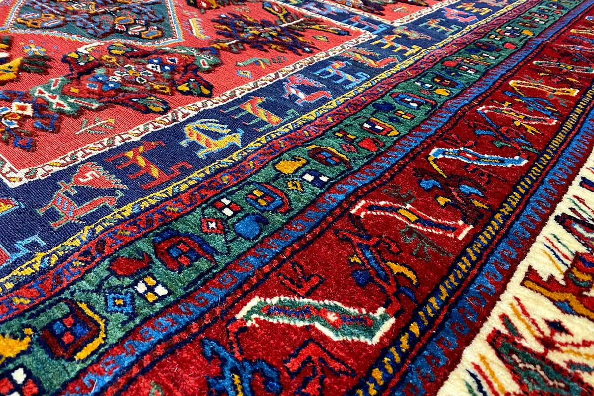 Carpet detail with multicolored ornaments, a dense woven pattern, and a textile surface