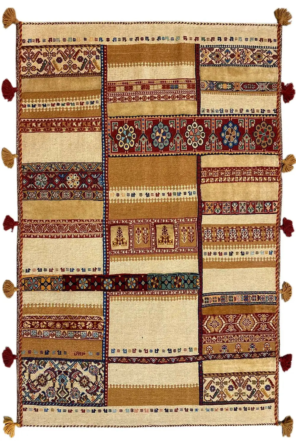 Rug with rectangular patchwork, a beige background and red/blue ornamental bands, tasseled edge.