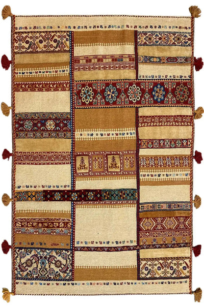 Rug with rectangular patchwork, a beige background and red/blue ornamental bands, tasseled edge.