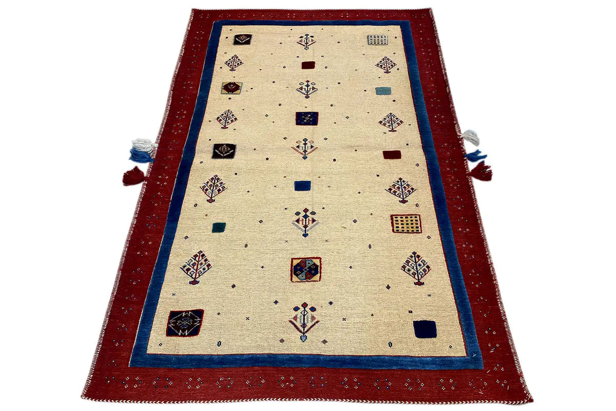 Beige rug with a red border, blue trim, and tassels